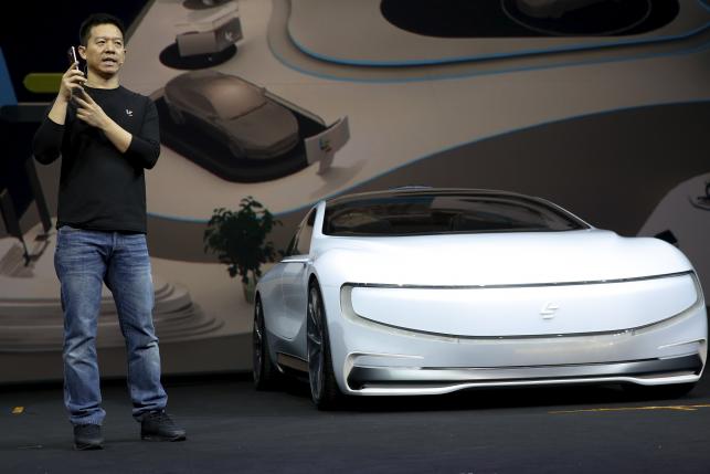 Jia, co-founder and head of Le Holdings Co Ltd, also known as LeEco and formerly as LeTV, gestures as he unveils an all-electric battery "concept" car called LeSEE during a ceremony in Beijingx